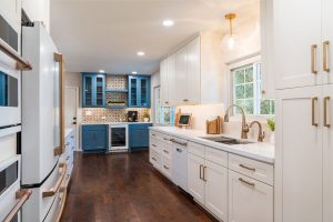 White kitchen with honey bronze hardware and a blue coffee bar