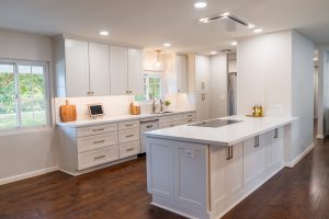 White kitchen with white subway tile and champagne hardward